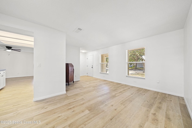 2036 Hogan Dr, Melbourne, FL 32935 - unfurnished living room featuring light wood-style flooring, baseboards, and ceiling fan