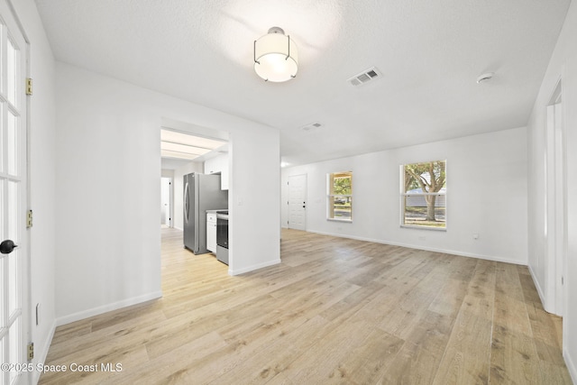 2036 Hogan Dr, Melbourne, FL 32935 - unfurnished living room with light wood-style floors and baseboards
