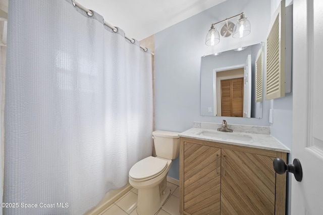 2036 Hogan Dr, Melbourne, FL 32935 - full bath featuring toilet, vanity, tile patterned flooring, and a shower with curtain