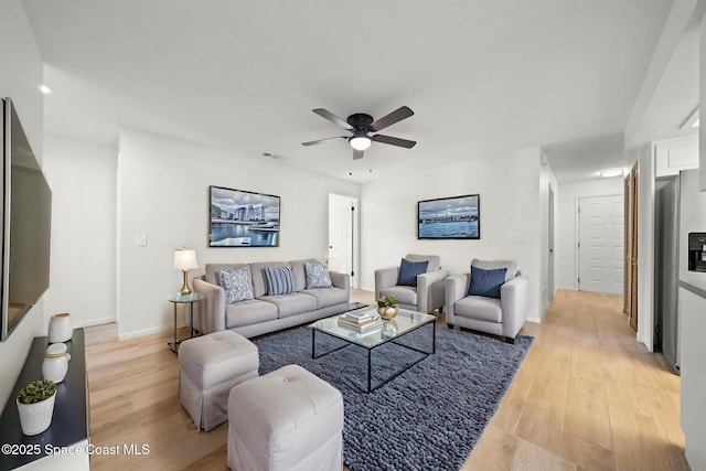 2036 Hogan Dr, Melbourne, FL 32935 - living room featuring ceiling fan, light wood-style floors, and baseboards