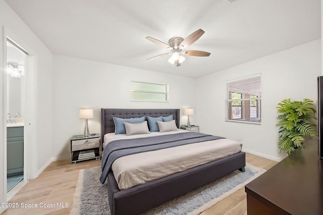 2036 Hogan Dr, Melbourne, FL 32935 - bedroom featuring light wood-style flooring, baseboards, ceiling fan, and connected bathroom