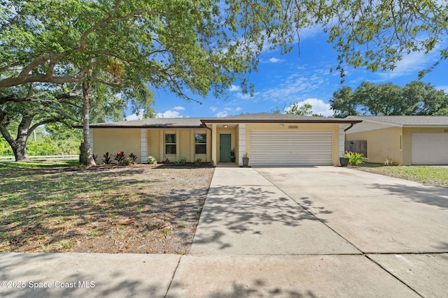 2036 Hogan Dr, Melbourne, FL 32935 - single story home featuring a garage, driveway, and stucco siding
