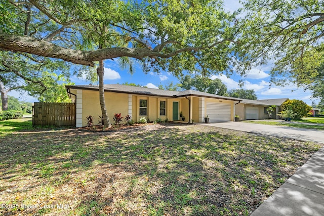2036 Hogan Dr, Melbourne, FL 32935 - view of front of house with a garage, driveway, and stucco siding