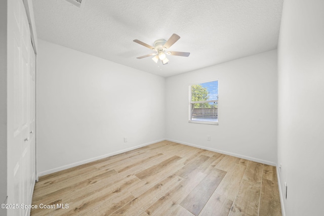 2036 Hogan Dr, Melbourne, FL 32935 - unfurnished room with wood finished floors, a ceiling fan, a textured ceiling, and baseboards
