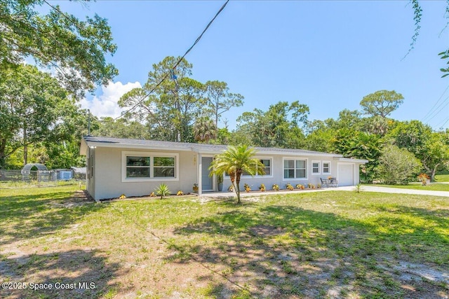 439 Blue Heron Rd, Melbourne Village, FL 32904 - view of front facade featuring a garage, stucco siding, and driveway