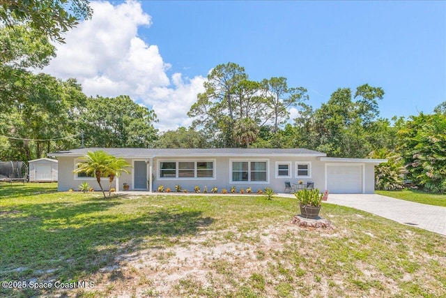 439 Blue Heron Rd, Melbourne Village, FL 32904 - single story home with a garage, driveway, a front lawn, and stucco siding