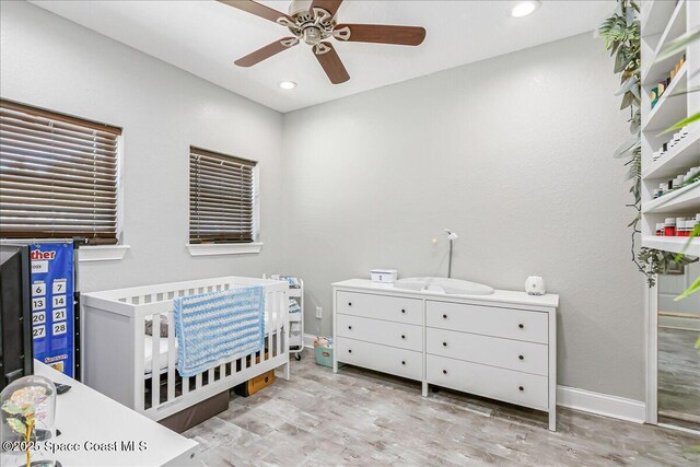439 Blue Heron Rd, Melbourne Village, FL 32904 - bedroom featuring wood finished floors, a nursery area, recessed lighting, and a ceiling fan