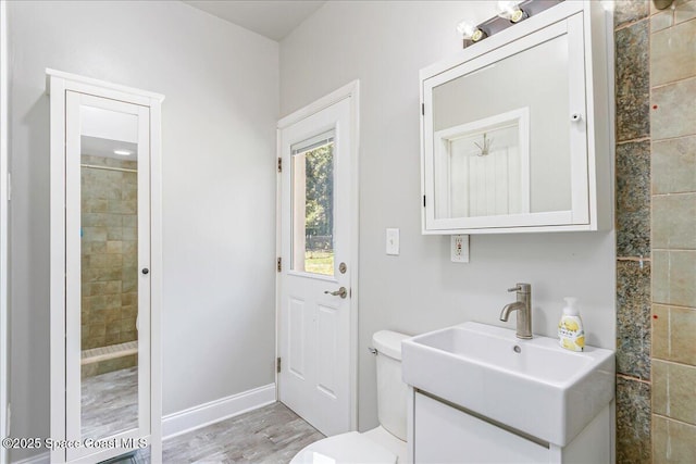 439 Blue Heron Rd, Melbourne Village, FL 32904 - bathroom featuring vanity, tiled shower, and wood finished floors