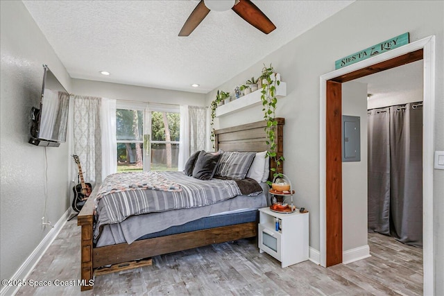 439 Blue Heron Rd, Melbourne Village, FL 32904 - bedroom with electric panel, a textured ceiling, wood finished floors, ceiling fan, and recessed lighting