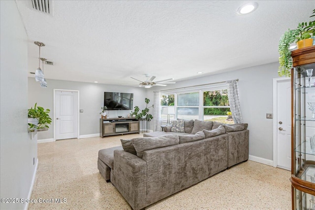 439 Blue Heron Rd, Melbourne Village, FL 32904 - living area with speckle patterned floor, ceiling fan, a textured ceiling, and recessed lighting