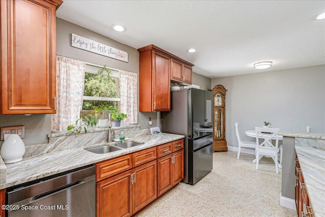 439 Blue Heron Rd, Melbourne Village, FL 32904 - kitchen featuring stainless steel dishwasher, freestanding refrigerator, light stone countertops, dark aggregate flooring, and brown cabinets
