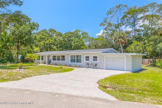 439 Blue Heron Rd, Melbourne Village, FL 32904 - ranch-style house with a garage, decorative driveway, and a front yard