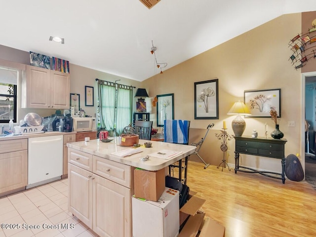 3625 2nd Ln, Vero Beach, FL 32968 - kitchen featuring white appliances, vaulted ceiling, light countertops, a kitchen island, and light brown cabinets