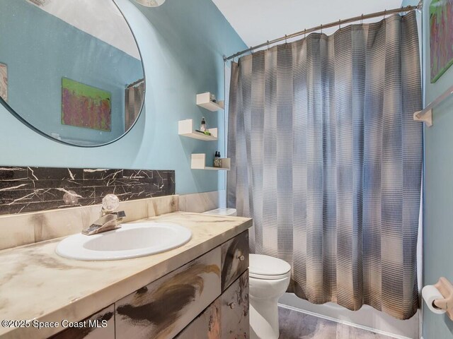 3625 2nd Ln, Vero Beach, FL 32968 - full bath with vanity, toilet, wood finished floors, and shower / bath combination with curtain