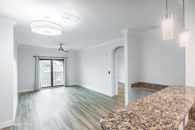 6421 Borasco Dr Unit 3208, Melbourne, FL 32940 - unfurnished living room with arched walkways, light wood-style floors, ceiling fan, baseboards, and ornamental molding