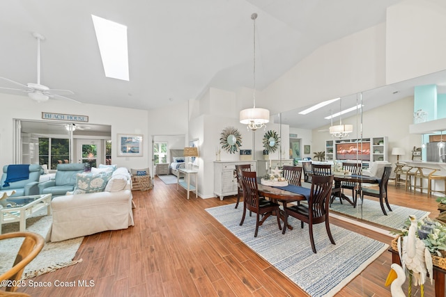 7701 Candlewick Dr, Melbourne, FL 32940 - dining area featuring high vaulted ceiling, a skylight, a ceiling fan, and wood finished floors