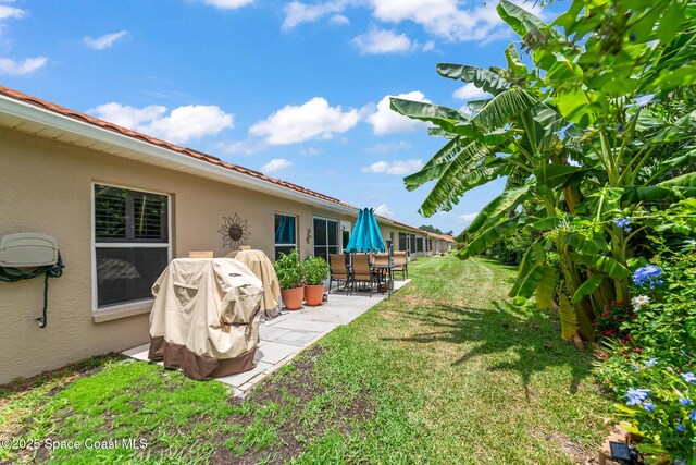 7701 Candlewick Dr, Melbourne, FL 32940 - view of grassy yard with a patio