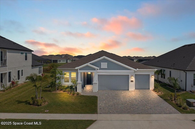 3234 Laming Way, Melbourne, FL 32940 - view of front facade with an attached garage, decorative driveway, and a yard