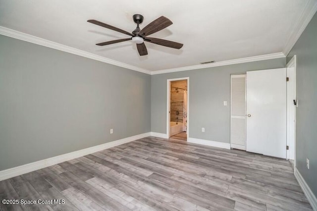 201 International Dr Unit 226, Cape Canaveral, FL 32920 - unfurnished bedroom featuring crown molding, baseboards, wood finished floors, ensuite bathroom, and ceiling fan