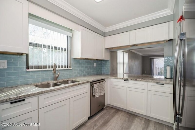 201 International Dr Unit 226, Cape Canaveral, FL 32920 - kitchen with appliances with stainless steel finishes, a sink, ornamental molding, white cabinets, and decorative backsplash