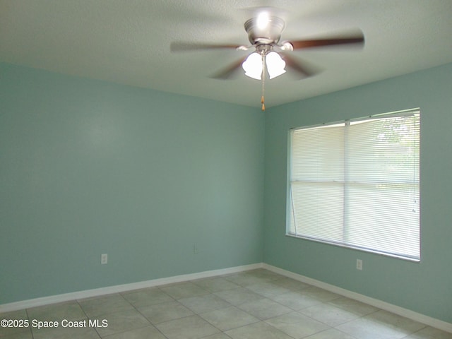 636 Fishtail Palm Blvd, Melbourne, FL 32901 - empty room with a ceiling fan, baseboards, and light tile patterned floors