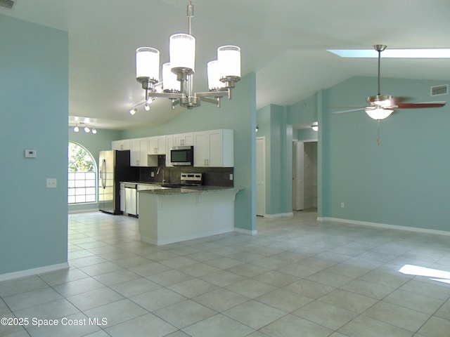 636 Fishtail Palm Blvd, Melbourne, FL 32901 - kitchen featuring appliances with stainless steel finishes, open floor plan, light tile patterned flooring, and lofted ceiling
