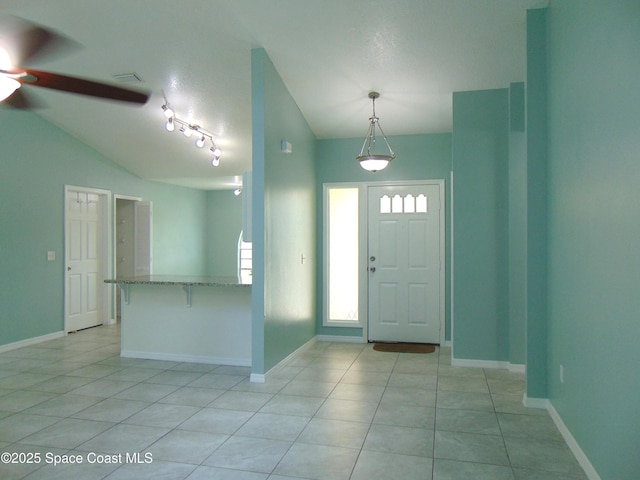 636 Fishtail Palm Blvd, Melbourne, FL 32901 - foyer featuring lofted ceiling, ceiling fan, light tile patterned floors, and baseboards