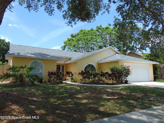636 Fishtail Palm Blvd, Melbourne, FL 32901 - single story home featuring an attached garage, stucco siding, concrete driveway, and a front lawn