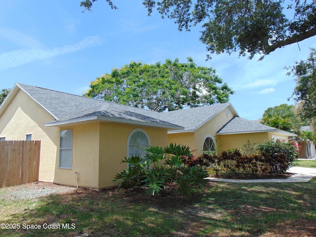 636 Fishtail Palm Blvd, Melbourne, FL 32901 - view of front of home with stucco siding and roof with shingles