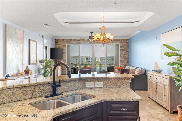 4125 W End Rd Unit 405, Cocoa Beach, FL 32931 - kitchen featuring a sink, light stone countertops, a chandelier, hanging light fixtures, and ornamental molding