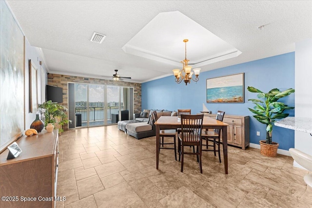 4125 W End Rd Unit 405, Cocoa Beach, FL 32931 - dining room with a ceiling fan, a chandelier, a raised ceiling, baseboards, and a textured ceiling