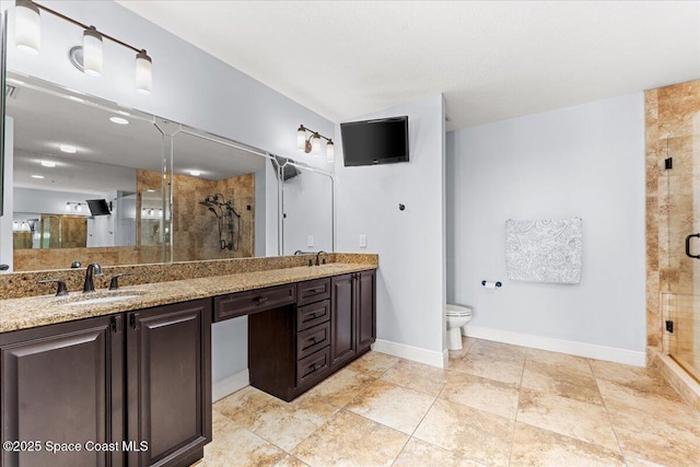 4125 W End Rd Unit 405, Cocoa Beach, FL 32931 - bathroom featuring double vanity, a stall shower, toilet, and baseboards