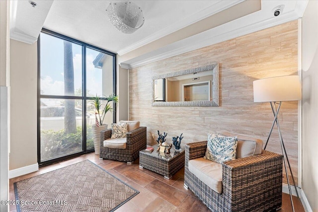 4125 W End Rd Unit 405, Cocoa Beach, FL 32931 - living area featuring crown molding, wood walls, expansive windows, and baseboards