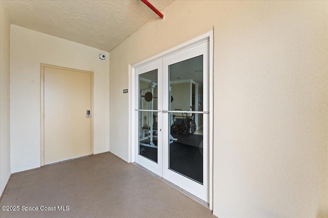 4125 W End Rd Unit 405, Cocoa Beach, FL 32931 - entrance to property with french doors, stucco siding, and a patio
