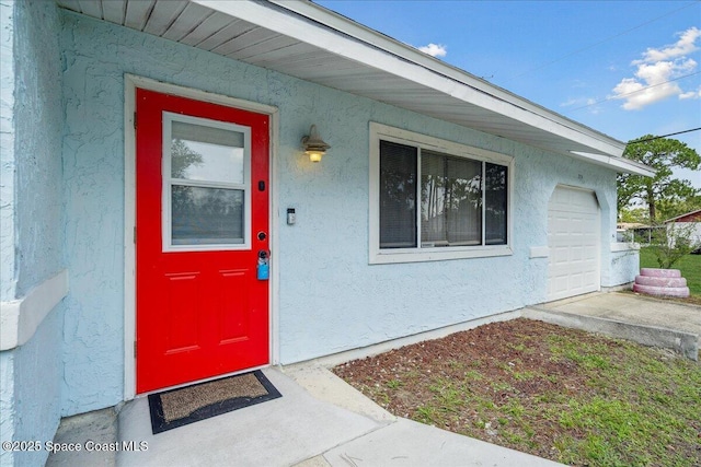 1750 Wapello Ave SE, Palm Bay, FL 32909 - view of exterior entry with stucco siding