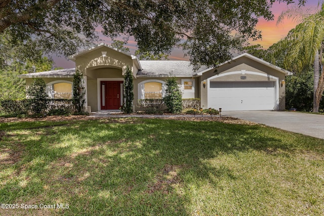 3220 Lowry Blvd SE, Palm Bay, FL 32909 - view of front of property with driveway, a front yard, stucco siding, and an attached garage