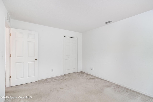 3220 Lowry Blvd SE, Palm Bay, FL 32909 - unfurnished bedroom featuring carpet floors, a closet, and baseboards