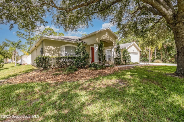 3220 Lowry Blvd SE, Palm Bay, FL 32909 - view of front facade with stucco siding, a front lawn, a garage, and driveway