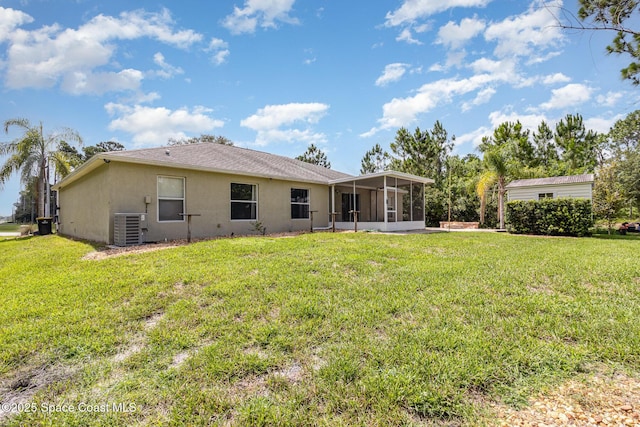 3220 Lowry Blvd SE, Palm Bay, FL 32909 - rear view of house featuring a sunroom, cooling unit, a lawn, and stucco siding