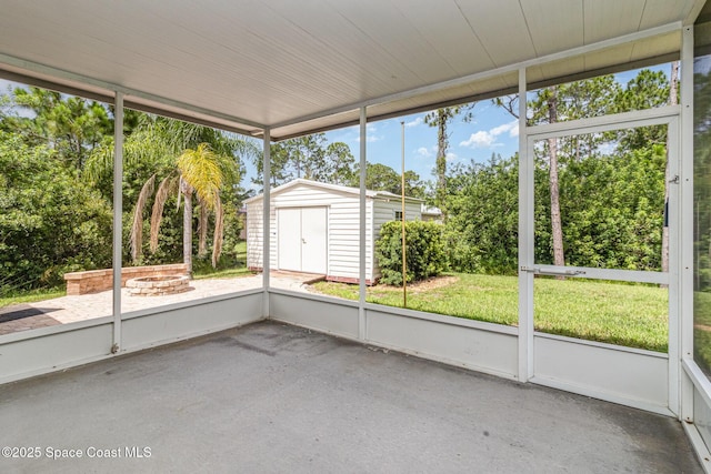 3220 Lowry Blvd SE, Palm Bay, FL 32909 - unfurnished sunroom featuring an outdoor fire pit and view of wooded area