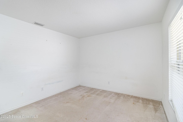 3220 Lowry Blvd SE, Palm Bay, FL 32909 - spare room featuring light colored carpet and baseboards
