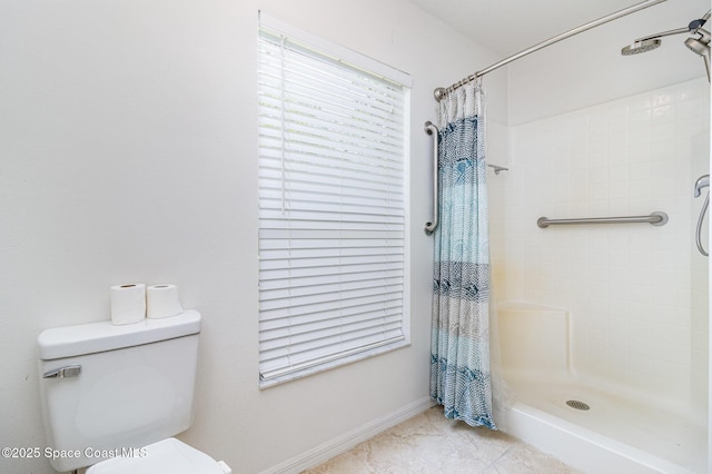 3220 Lowry Blvd SE, Palm Bay, FL 32909 - bathroom with tiled shower, toilet, baseboards, and tile patterned flooring