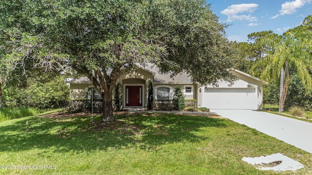 3220 Lowry Blvd SE, Palm Bay, FL 32909 - obstructed view of property featuring concrete driveway, stucco siding, an attached garage, and a front yard
