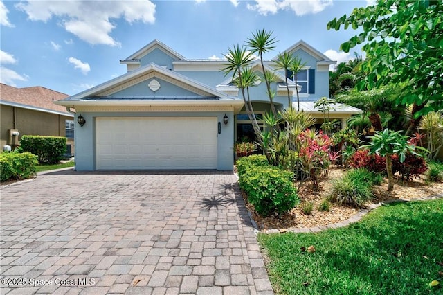 121 Amherst Ln, Sebastian, FL 32958 - view of front of house featuring decorative driveway, stucco siding, and a garage