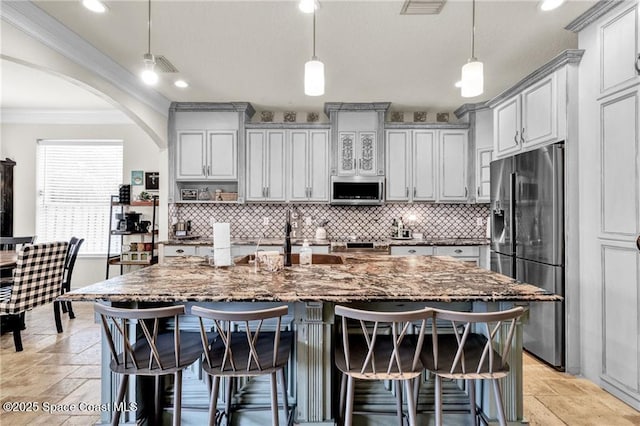 121 Amherst Ln, Sebastian, FL 32958 - kitchen with appliances with stainless steel finishes, crown molding, backsplash, dark stone counters, and recessed lighting