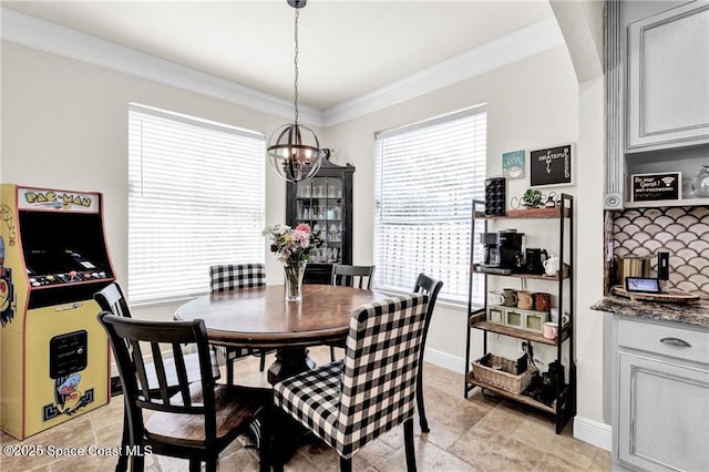121 Amherst Ln, Sebastian, FL 32958 - dining room with a chandelier, stone finish floors, crown molding, and baseboards