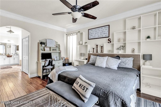 121 Amherst Ln, Sebastian, FL 32958 - bedroom featuring wood finished floors, ornamental molding, arched walkways, ensuite bath, and ceiling fan