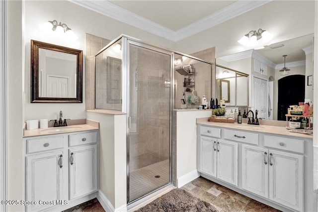 121 Amherst Ln, Sebastian, FL 32958 - full bath featuring a shower stall, two vanities, crown molding, and baseboards