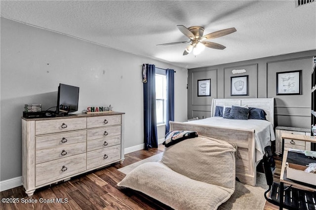 121 Amherst Ln, Sebastian, FL 32958 - bedroom with baseboards, dark wood-style flooring, a ceiling fan, and a textured ceiling