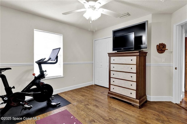 121 Amherst Ln, Sebastian, FL 32958 - exercise area featuring baseboards, a ceiling fan, and wood finished floors